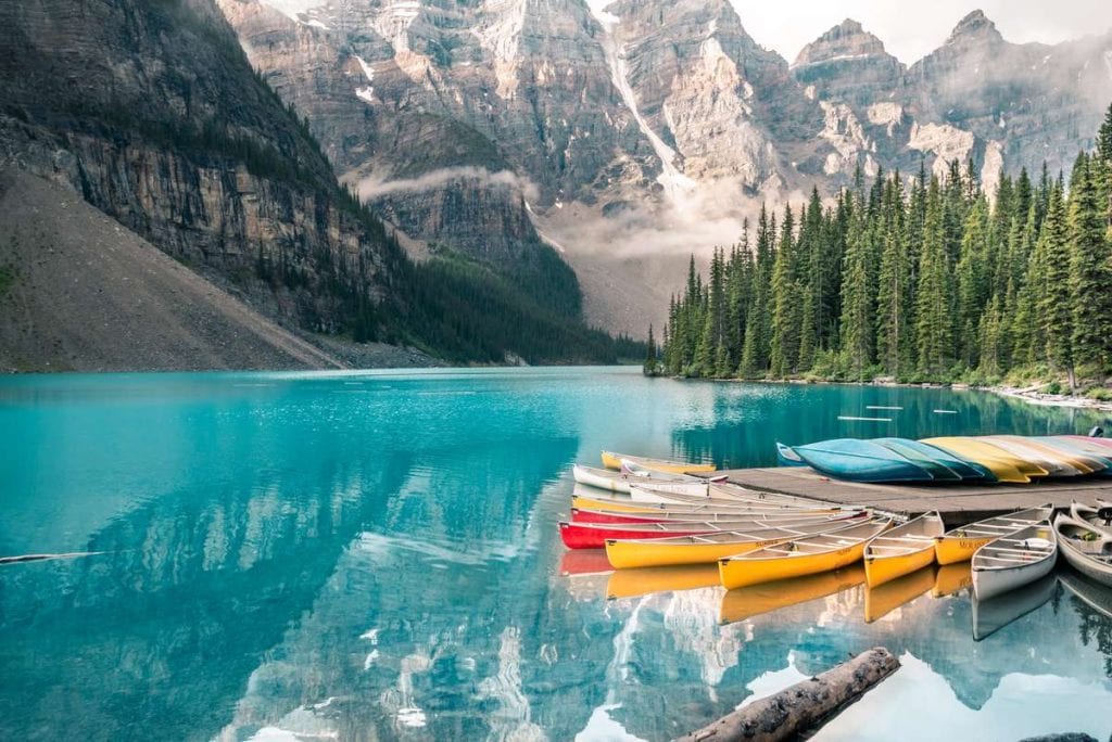 Moraine lake in Banff national park Alberta Canada canoes mountains deep blue green lake